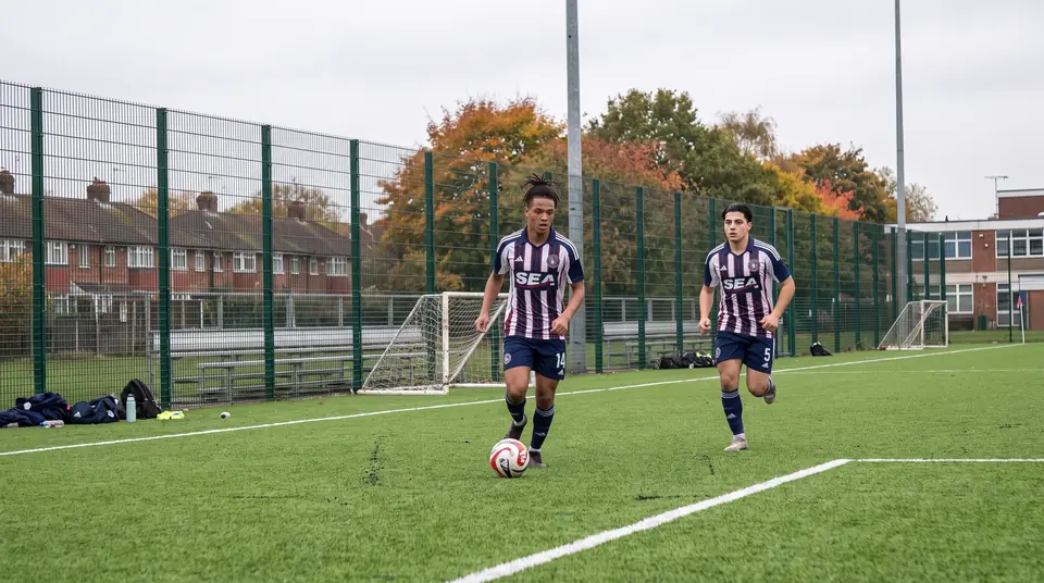 Gabriel Costa (#14) on the ball with Omar Khalil (#5) chasing in training on the turf